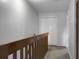 Upstairs hallway with wooden railing, a large closet, and carpeted floors at 6240 April Pine Cir # B, North Charleston, SC 29406