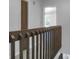 Upstairs hallway with wooden railing and doors at 6240 April Pine Cir # B, North Charleston, SC 29406