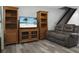 Living area featuring wood shelving and a large TV at 6240 April Pine Cir # B, North Charleston, SC 29406