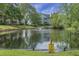Serene pond with fountain, surrounded by lush greenery and homes at 6240 April Pine Cir # B, North Charleston, SC 29406