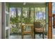 Relaxing screened porch with wooden table and chair, overlooking lush greenery at 6240 April Pine Cir # B, North Charleston, SC 29406