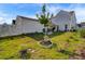 Landscaped backyard with a detached garage and a tree at 645 Blueway Ave, Summerville, SC 29486
