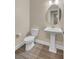 Clean bathroom with white toilet and pedestal sink at 645 Blueway Ave, Summerville, SC 29486