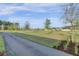 Landscaped green space with a paved path at 645 Blueway Ave, Summerville, SC 29486