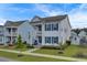Two-story white house with blue shutters, charming porch, and landscaped yard at 645 Blueway Ave, Summerville, SC 29486