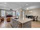 Open concept kitchen and living area with island, stainless steel appliances, and hardwood floors at 645 Blueway Ave, Summerville, SC 29486