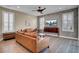 Living room boasts hardwood floors, leather sofas, and a stylish wood accent wall at 645 Blueway Ave, Summerville, SC 29486
