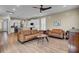 Open living area with hardwood floors, leather furniture, and views into the kitchen at 645 Blueway Ave, Summerville, SC 29486