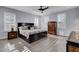 Main bedroom with king bed, wood floors, and large windows at 645 Blueway Ave, Summerville, SC 29486
