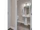 Elegant powder room with pedestal sink and wood-look tile floor at 645 Blueway Ave, Summerville, SC 29486