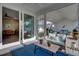 Relaxing screened porch with wicker furniture, a coffee table, and a blue rug at 645 Blueway Ave, Summerville, SC 29486