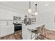 Modern kitchen with white cabinets, island, and stainless steel appliances at 741 Meadowbrook Ln, Summerville, SC 29486