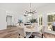 Bright dining room with round table, chandelier, and access to backyard patio at 747 Meadowbrook Ln, Summerville, SC 29486