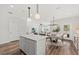 Open concept kitchen with white island and breakfast bar, hardwood floors at 747 Meadowbrook Ln, Summerville, SC 29486