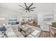 Open concept living room with hardwood floors, a ceiling fan and view into kitchen at 747 Meadowbrook Ln, Summerville, SC 29486