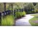 Curved walking path with lush landscaping and fencing at 752 Meadowbrook Ln, Summerville, SC 29486