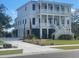 Two-story home with white siding, multiple balconies, and a three-car garage at Cir, Mount Pleasant, SC 29464