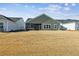 Large backyard with a view of the home's exterior at 1104 Cooper Point St, Summerville, SC 29485