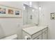 Bathroom with white cabinets, quartz countertop, and a large mirror at 1104 Cooper Point St, Summerville, SC 29485