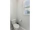 Simple and clean bathroom with a toilet and a window at 1104 Cooper Point St, Summerville, SC 29485
