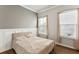 Bright bedroom with two windows, wood floors, and neutral decor at 1104 Cooper Point St, Summerville, SC 29485