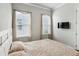 Spacious bedroom with wood floors, neutral decor and mounted TV at 1104 Cooper Point St, Summerville, SC 29485