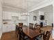Bright dining room features hardwood floors and view of living room at 1104 Cooper Point St, Summerville, SC 29485