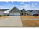 Two-car garage and driveway, house with green siding at 1104 Cooper Point St, Summerville, SC 29485