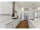 Modern kitchen with white cabinets, quartz countertops, and stainless steel appliances at 1104 Cooper Point St, Summerville, SC 29485