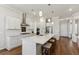 Modern kitchen with white cabinets, quartz countertops, and stainless steel appliances at 1104 Cooper Point St, Summerville, SC 29485