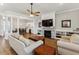 Open living room features hardwood floors and a view into the dining area at 1104 Cooper Point St, Summerville, SC 29485