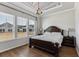 Main bedroom with hardwood floors, decorative ceiling and large windows at 1104 Cooper Point St, Summerville, SC 29485