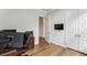 Bright home office with wood floors, ample space, and built-in shelving at 1104 Cooper Point St, Summerville, SC 29485