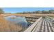 Wooden deck and pier overlooking tranquil marshland at 1158 Village Creek Lane Unit 4 # 803, Mount Pleasant, SC 29464