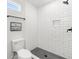 Bathroom with white subway tile shower and dark floor at 1994 Groveland Ave, North Charleston, SC 29405
