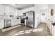 Modern kitchen with white cabinets, stainless steel appliances, and quartz countertops at 1994 Groveland Ave, North Charleston, SC 29405