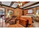 Bedroom with wood-paneled walls, ceiling beams, and a relaxing sitting area at 2007 Central Ave, Summerville, SC 29483