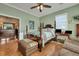 Bedroom with hardwood floors, large bed, and access to other rooms at 2007 Central Ave, Summerville, SC 29483