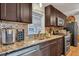 Kitchen boasts granite countertops and dark cabinetry at 2007 Central Ave, Summerville, SC 29483