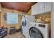 Bright laundry room with washer, dryer, and ample storage at 2007 Central Ave, Summerville, SC 29483