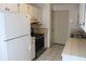 Galley kitchen with white appliances and tile floor at 201 Regent St, Summerville, SC 29483