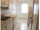 Simple kitchen with white cabinets and tile flooring at 201 Regent St, Summerville, SC 29483