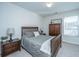 Cozy bedroom with wood bed frame, dark wood armoire and window at 264 Godwit Dr, Summerville, SC 29486