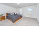 Spacious bedroom with wood bed frame, carpeted floor, and two windows at 264 Godwit Dr, Summerville, SC 29486