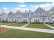 Row of townhouses with gray and beige siding, lush lawns, and sidewalks at 264 Godwit Dr, Summerville, SC 29486