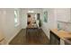 Modern dining area with wood table and chairs, hardwood floors, and view into living room at 2744 E Surrey Dr, North Charleston, SC 29405