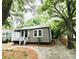 Updated bungalow with a gravel driveway and mature trees at 2744 E Surrey Dr, North Charleston, SC 29405