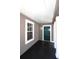 Inviting front porch with dark flooring and green door at 2744 E Surrey Dr, North Charleston, SC 29405
