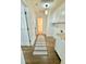 Clean hallway with hardwood floors, laundry area, and access to other rooms at 2744 E Surrey Dr, North Charleston, SC 29405