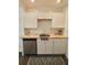 Modern kitchen with white cabinets, stainless steel dishwasher, and light countertops at 2744 E Surrey Dr, North Charleston, SC 29405
